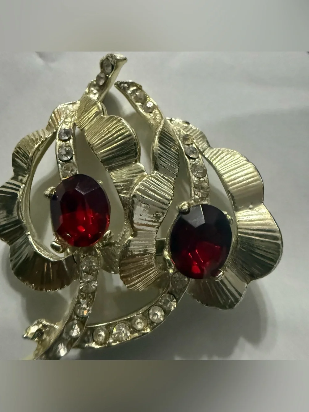 Vintage gold tone leaf brooch with red and clear rhinestones